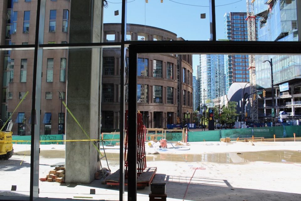 Looking out of building and Amazon's future office tower lobby towards Vancouver Public Library