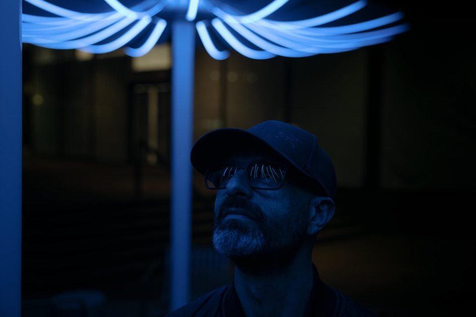 Bentall Centre parasols - A man's face is lit by the LED lighting